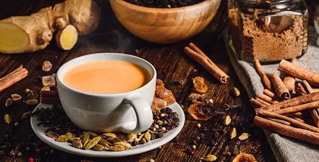 A cup of our signature masala chai with its spices